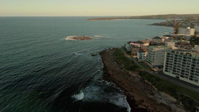 Aerial drone view of Cronulla heading toward Shark Island in Sutherland Shire, South Sydney, NSW Australia during late afternoon summer in February 2025    