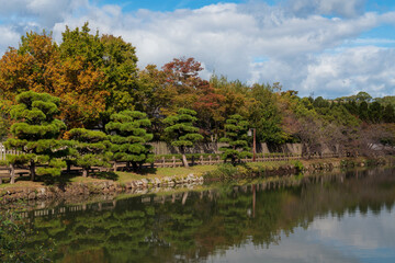 The Moat around the Himeji Castle ("White Egret Castle" or "White Heron Castle") along the Koko-en garden on a sunny autumn day, Himeji, Hyogo Prefecture, Japan