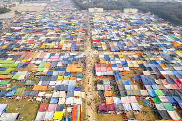 Festival ground where people have put up colorful tents to protect from the sun and the hea