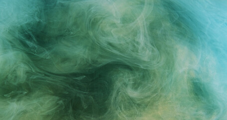 Glitter smoke. Ink water splash. Defocused blue gold color sparkling texture haze swirl wave spreading abstract art background.