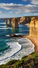 A scenic coastal road winding along the cliffs, with the Twelve Apostles rock formations rising from the sea.
