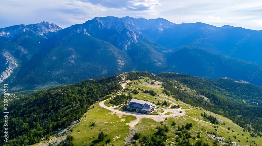 Aufkleber scenic mountain top view with lone cabin amidst vast green landscape and majestic mountain range in 