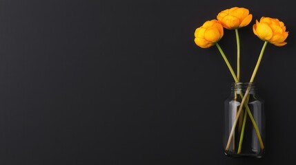 A vibrant display of yellow flowers in a glass jar against a dark background, showcasing natural beauty.