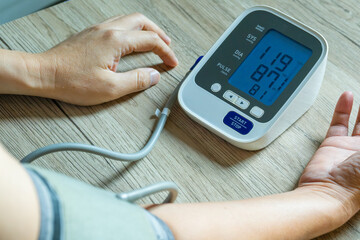 Man check blood pressure monitor and heart rate monitor with digital pressure gauge. Health care and Medical concept	