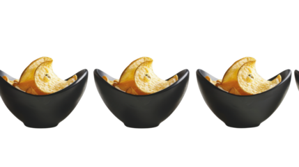 Banana chips overflowing three black bowls on transparent background