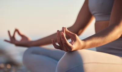Rolgordijnen Woman, hands or lotus pose meditation on sunset beach, ocean or sea in mental health, mind training or chakra balance. Zoom, peace or zen yogi in calm mudra, relax yoga wellness or sunrise gratitude © peopleimages.com