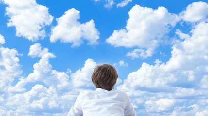 Person Gazing at Serene Blue Sky with Clouds