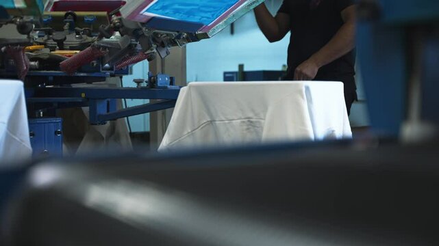 Medium abstract view of fabric moving through screenprinting machine rotating through layers, showcasing design application and vibrant details