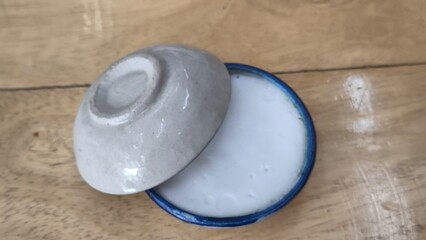 Thai dessert (khanom thuay) coconut milk custard in small porcelain cup .