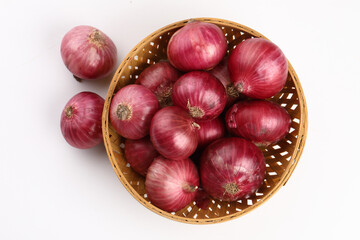 Fresh red onions in a bamboo basket. Harvest concepts. Organic vegetables.