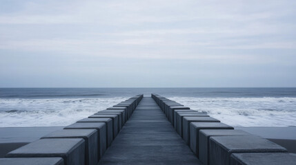 Fototapeta premium serene view of concrete pathway leading to ocean, surrounded by gentle waves and cloudy sky. scene evokes sense of calm and tranquility