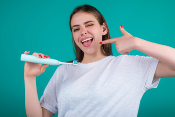 Brushing teeth. Woman holding toothbrush for tooth brushing. Dentistry, white tooth. Healthy teeth and dental care. Whitening toothpaste and brush. Cleaning teeth. Oral hygiene.
