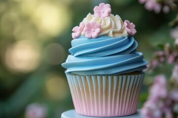 Blue cupcake tower with pastel pink accents, set against a soft garden backdrop.