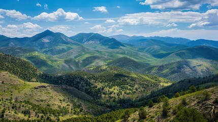 Obraz premium A wide mountain landscape, featuring rolling hills and diverse terrain,