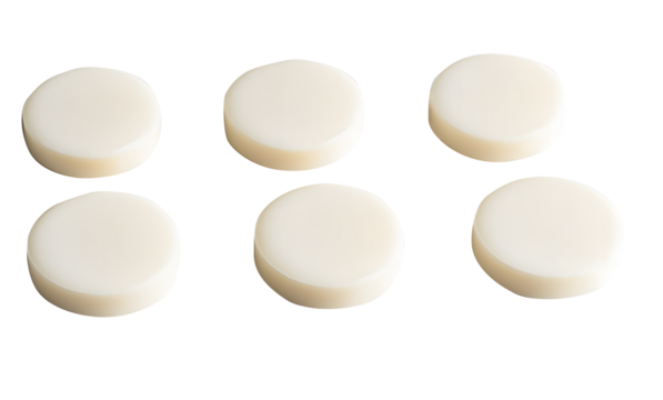 Round milk tablets arranged neatly isolated on cut out PNG or transparent background. Vitamins and calcium nourish body. Emphasizing their smooth texture and creamy color. Health and dietary product.