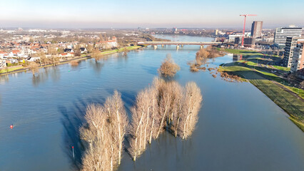 Aerial drone view of high water in Maas river and Venlo town cityscape from above, flood in the Netherlands