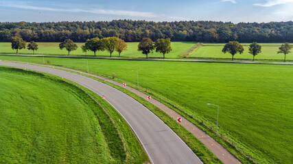 Aerial drone view of asphalt motorway road and bicycle lane from above, transportation infrastructure of the Netherlands