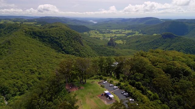 Expansive aerial drone footage of Binna Burra, highlighting the rugged mountain ranges, lush rainforest, and deep valleys of the Gold Coast Hinterland with stunning natural beauty.