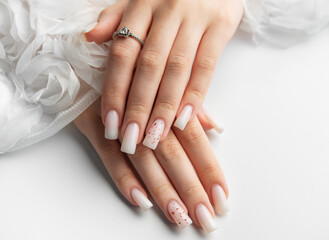 Bride showing her beautiful white nails and engagement ring