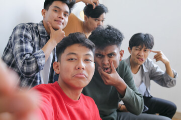 Portrait of Funny Diverse Man Doing Selfie Together With Silly Face