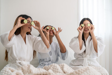 Diverse group of beauty women enjoy skincare routine, applying cucumber eye masks for hydration and wrinkle free skin, beauty self care spa, cosmetic, glowing and refreshing facial treatment at home