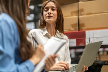 Fototapeta premium Female engineers team discussing inventory in warehouse logistics and supply chain planning, operation management, data analysis, warehouse shipping, inventory tracking, optimization and technology