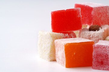 Colorful fruit-flavored jelly cubes arranged attractively on a plain background