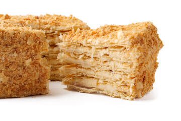 Delicious layered pastry with cream filling and crunchy topping on a white background showcasing its texture
