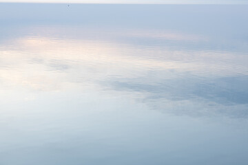 Reflection of the early dawn blue sky in the water.