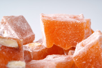 Orange Turkish delight pieces arranged on a light background highlighting the texture and sweetness of the dessert