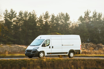 Blank white delivery van on road © AlexGo