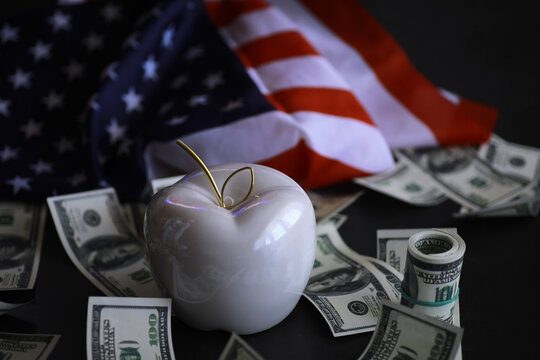 Apple on table with money, dollars banknotes. Us business concept. New york big apple.