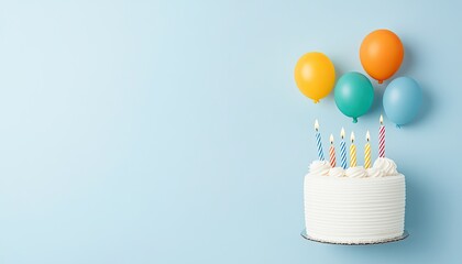 Festive birthday cake with candles and colorful balloons against a light blue background