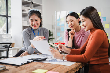 Asian people, motivated businesswoman at her desk, brainstorming creative ideas to kickstart her...