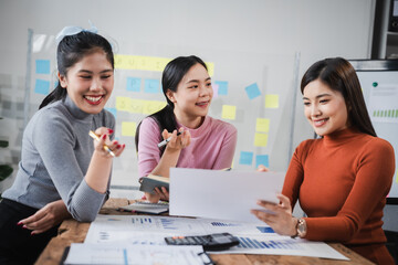 Asian people, motivated businesswoman at her desk, brainstorming creative ideas to kickstart her startup venture with determination and innovation. purpose and ambition. only women.
