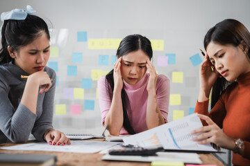 Asian people, frustrated businesswoman sits at desk, grappling with challenges of her startup, acknowledging failure, and seeking ways to learn and grow. team meeting. blamed