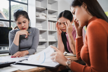 Asian people, frustrated businesswoman sits at desk, grappling with challenges of her startup, acknowledging failure, and seeking ways to learn and grow. team meeting. blamed