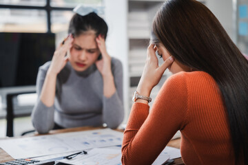 Asian people, frustrated businesswoman sits at desk, grappling with challenges of her startup, acknowledging failure, and seeking ways to learn and grow. team meeting. blamed