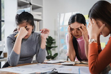Asian people, frustrated businesswoman sits at desk, grappling with challenges of her startup, acknowledging failure, and seeking ways to learn and grow. team meeting. blamed