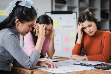 Asian people, frustrated businesswoman sits at desk, grappling with challenges of her startup,...