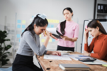 Asian people, frustrated businesswoman sits at desk, grappling with challenges of her startup, acknowledging failure, and seeking ways to learn and grow. team meeting. blamed