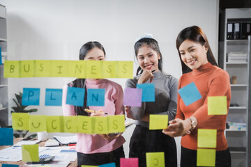 Asian people, motivated businesswoman at her desk, brainstorming creative ideas to kickstart her startup venture with determination and innovation. purpose and ambition. only women.
