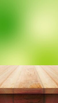 Empty wooden table with green blur vertical background video looping for display product reels video aor stories instagram