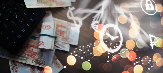 Russian rubles are on the table next to the computer, Notepad in the office or Bank. Savings and investments in the conditions of sanctions and inflation.