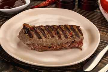 Grilled beef striploin steak with sauce