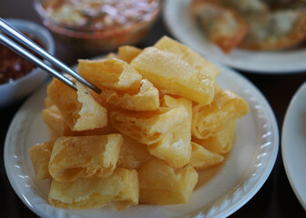 Tai yellow rectangular tofu, scored in the middle, and deep fried from Shan state, Myanmar
