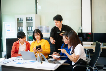 Business teamwork and collaboration among Asian professionals in a modern office