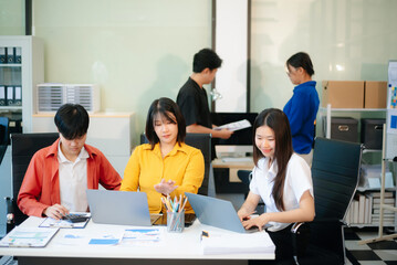 Business teamwork and collaboration among Asian professionals in a modern office