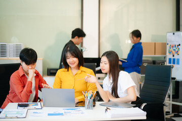 Business teamwork and collaboration among Asian professionals in a modern office