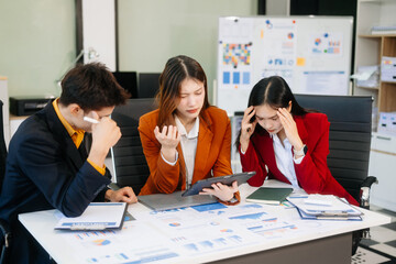 Furious two Asian businesspeople arguing strongly after making a mistake at work